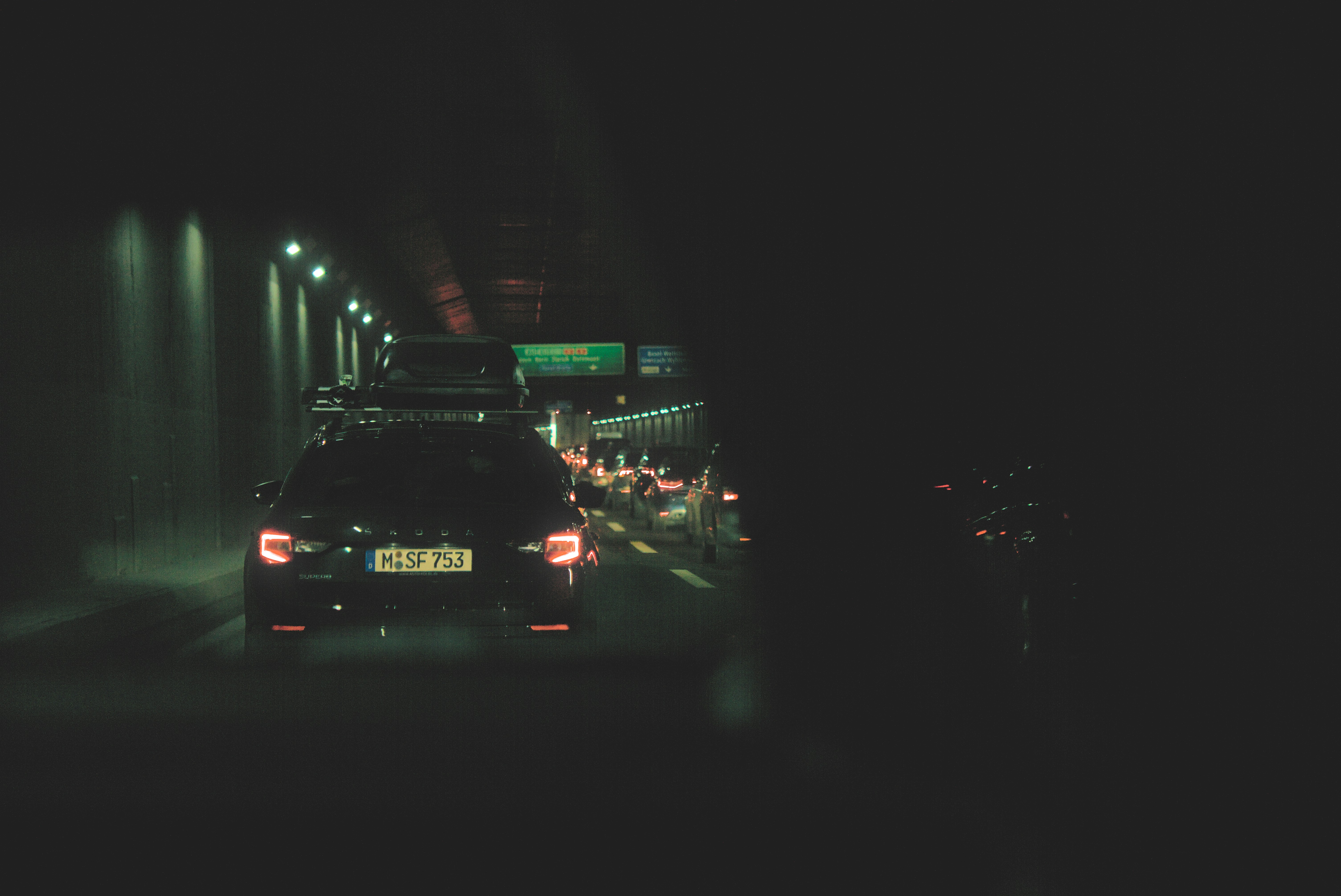 a car driving down a street at night