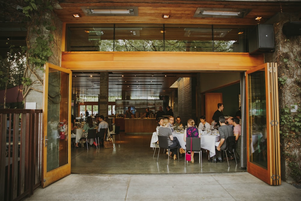 a group of people sitting at a table outside of a restaurant