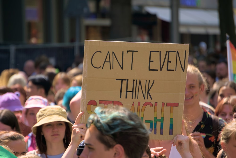 a group of people holding up a sign that says can't even think straight