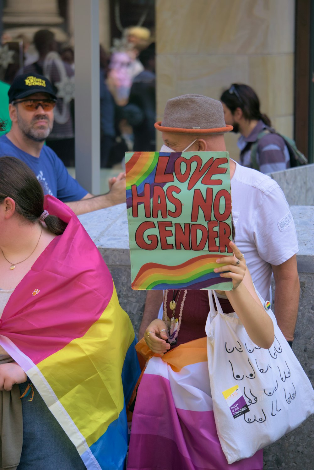 a woman holding a sign that says love has no gender