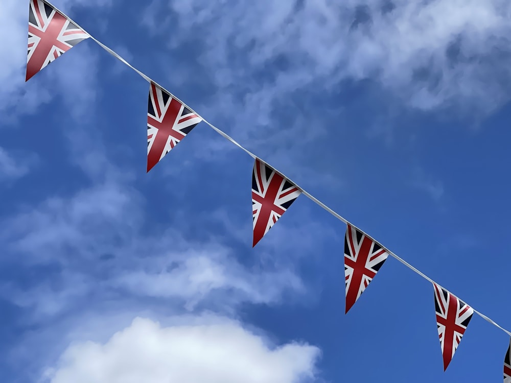 a bunch of flags that are hanging in the air