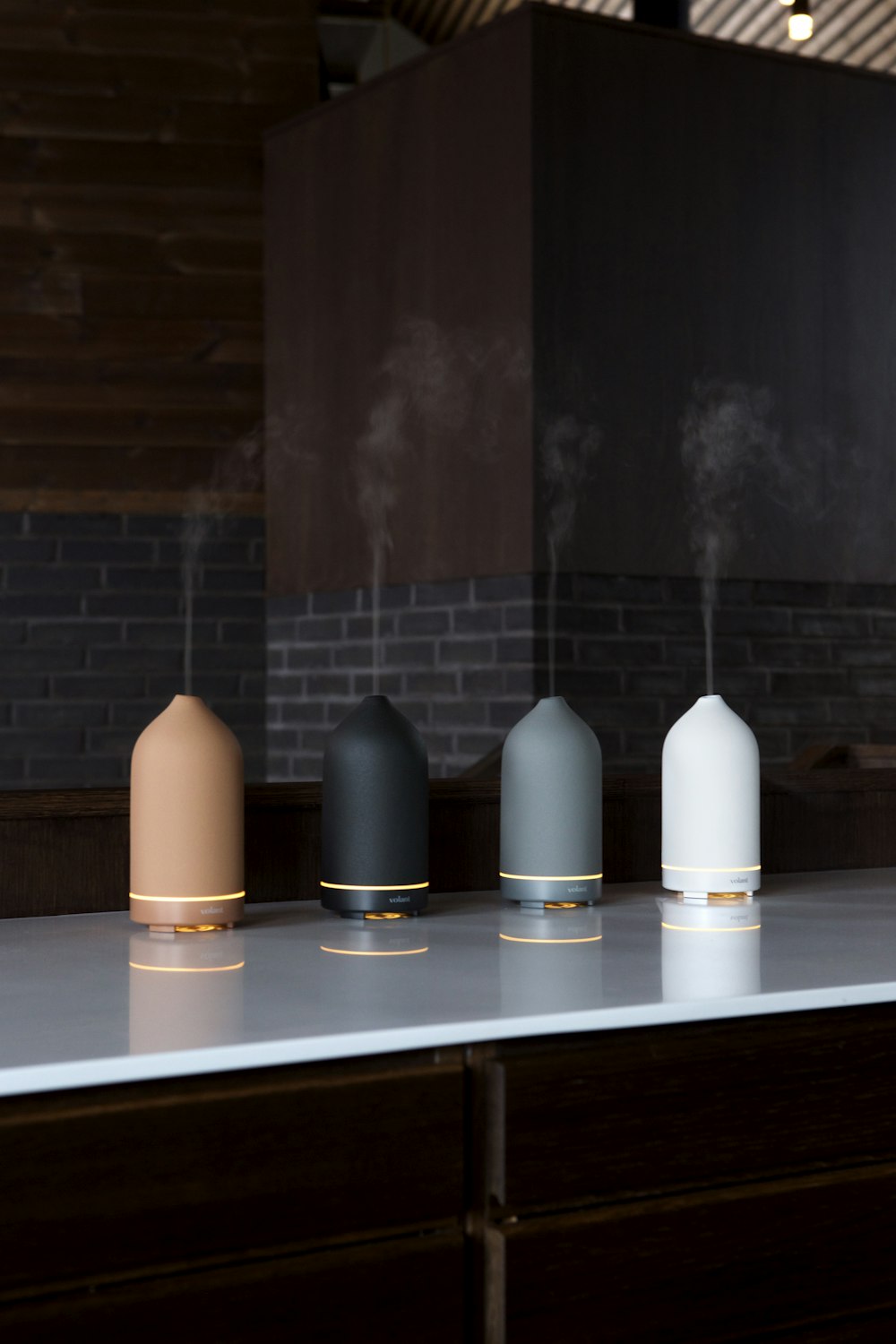 a group of three different colored air humiders on a counter