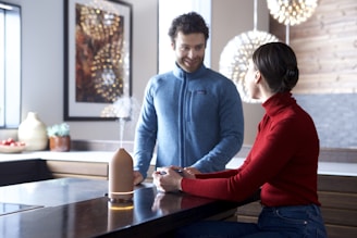 A friendly gas technician consulting with a homeowner in a cozy kitchen.