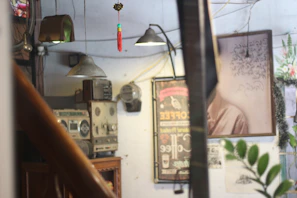 A cozy vintage radio setup with retro posters from the 60s on the wall.