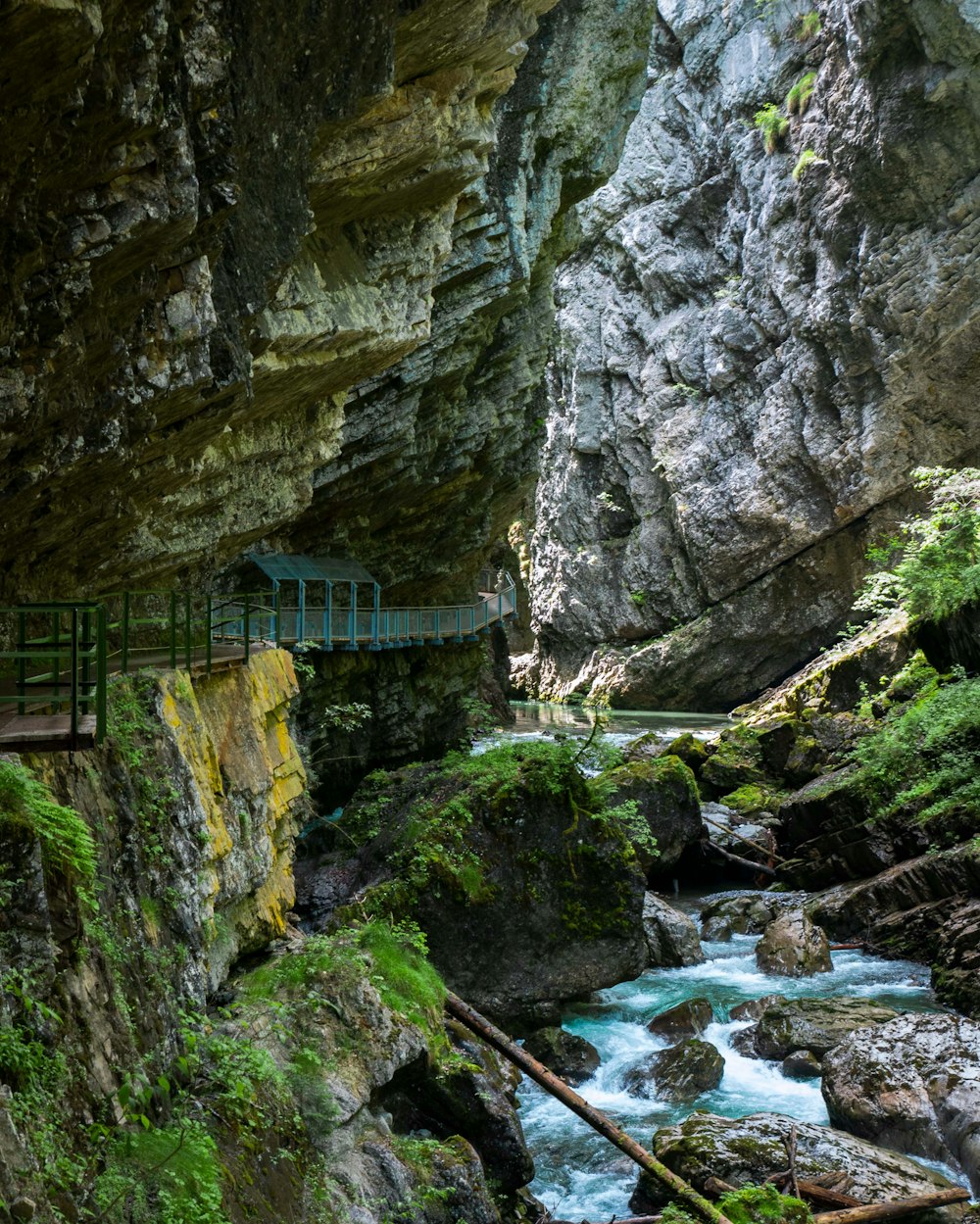 a bridge over a small stream in a canyon