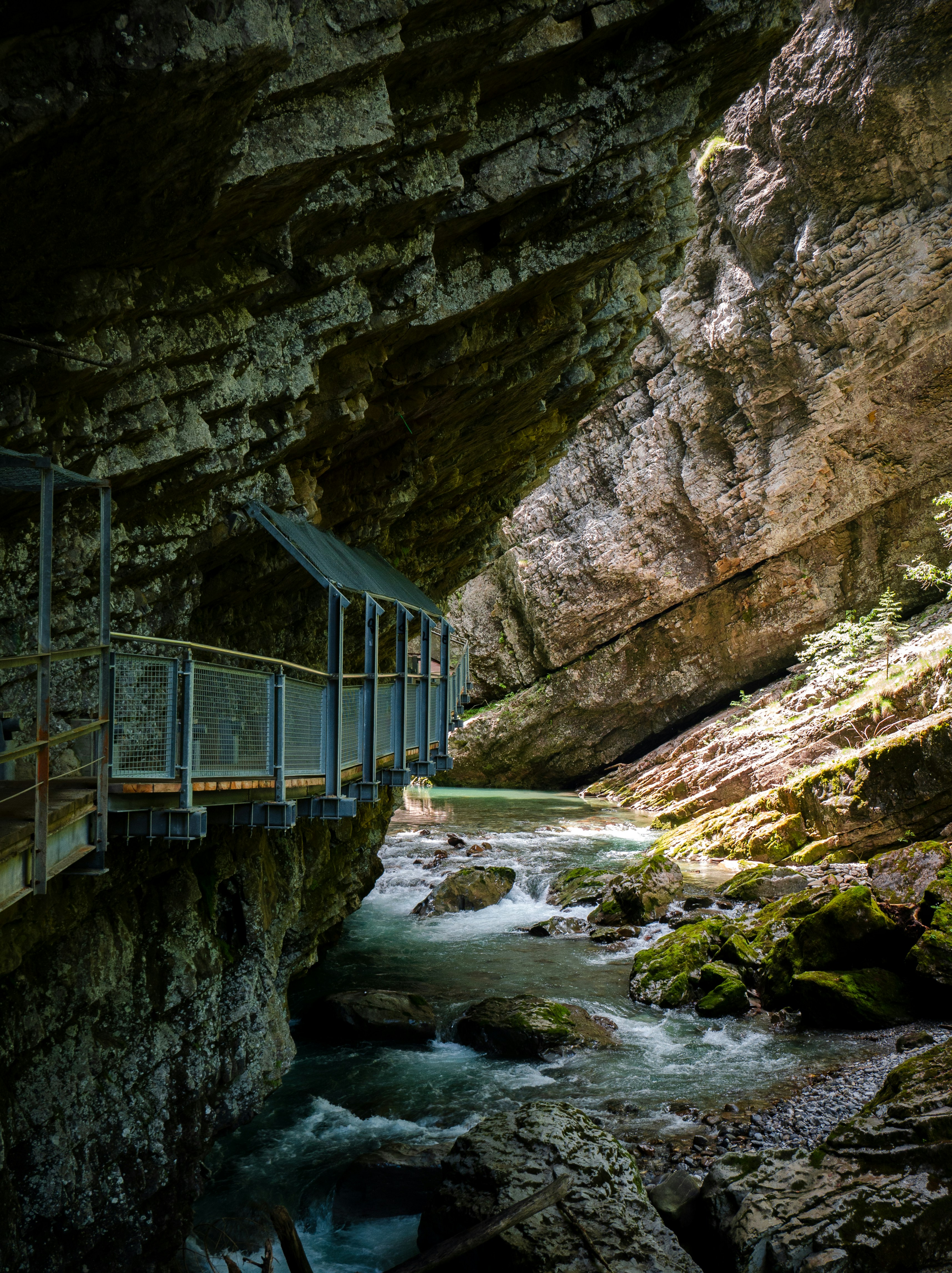a bridge over a river in a canyon