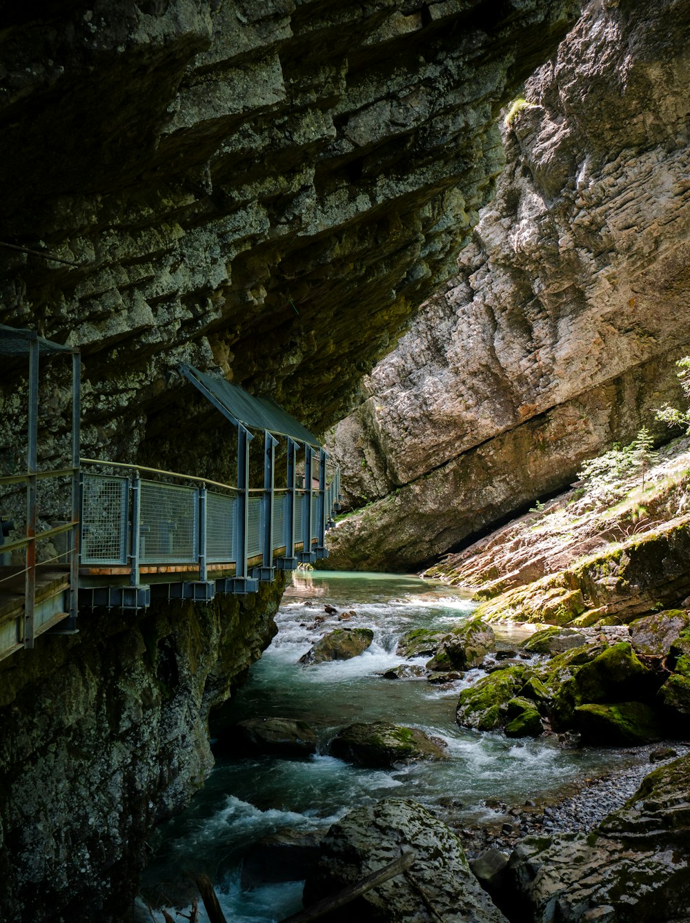 a bridge over a river in a canyon