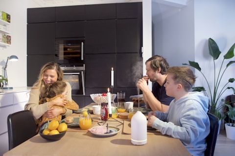 a group of people sitting around a table eating food