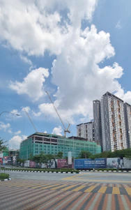 A skilled construction worker reviewing blueprints on a bustling site with cranes and scaffolding in the background.