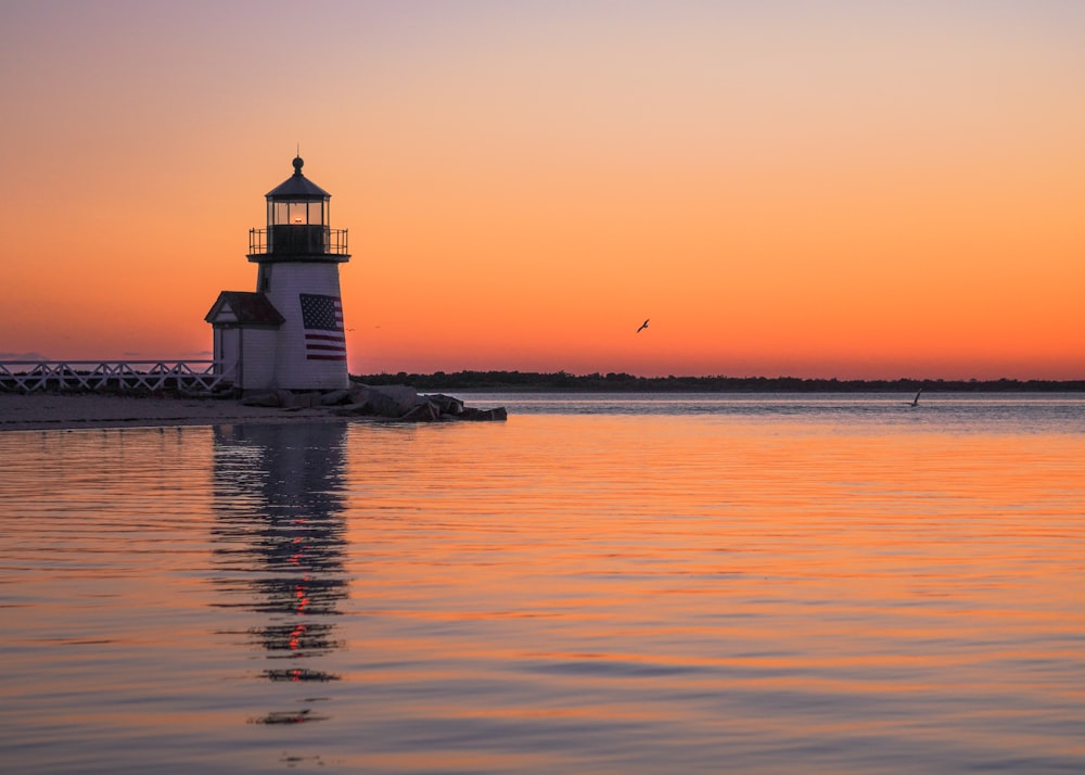 a light house sitting on top of a body of water