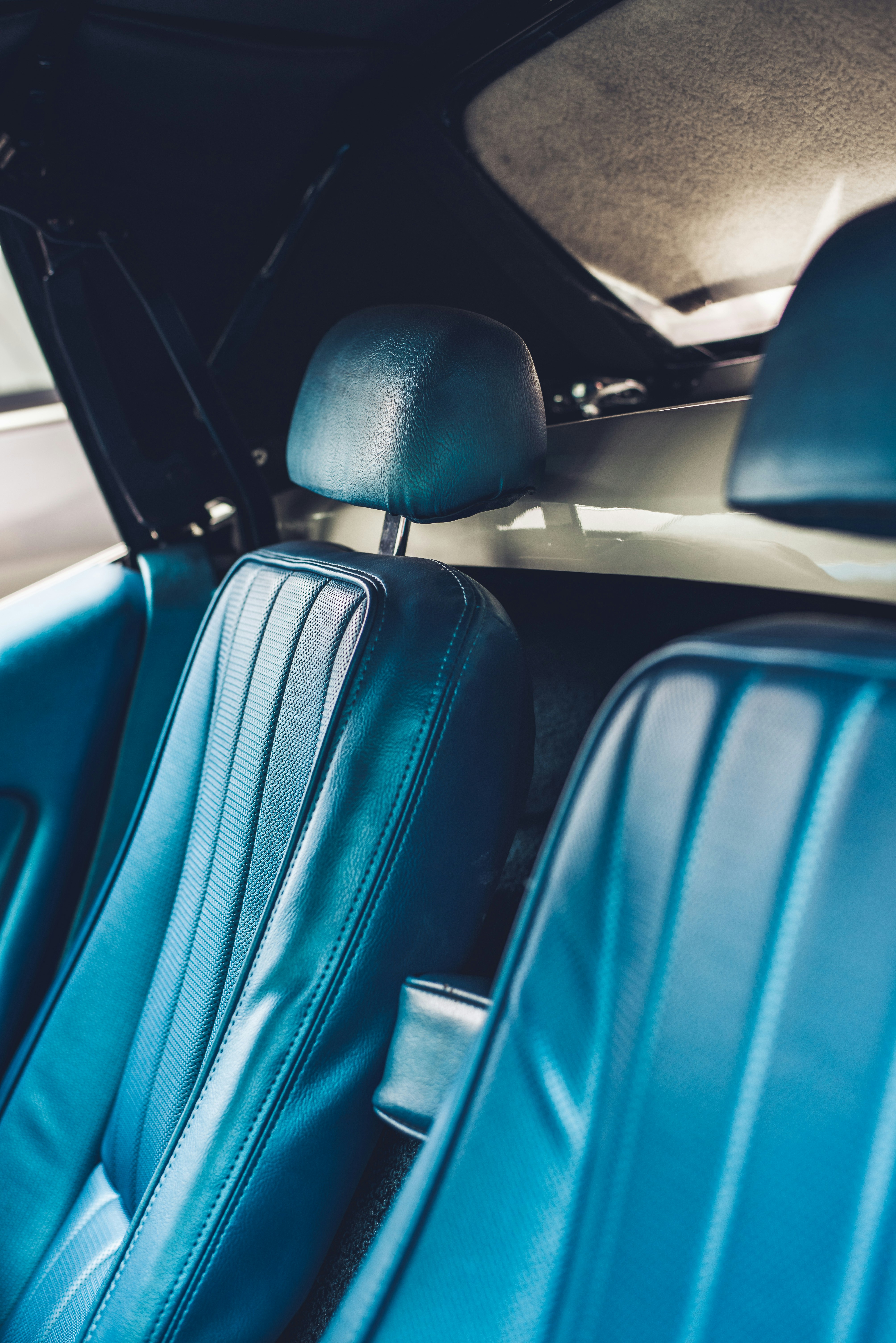 the interior of a car with blue leather seats
