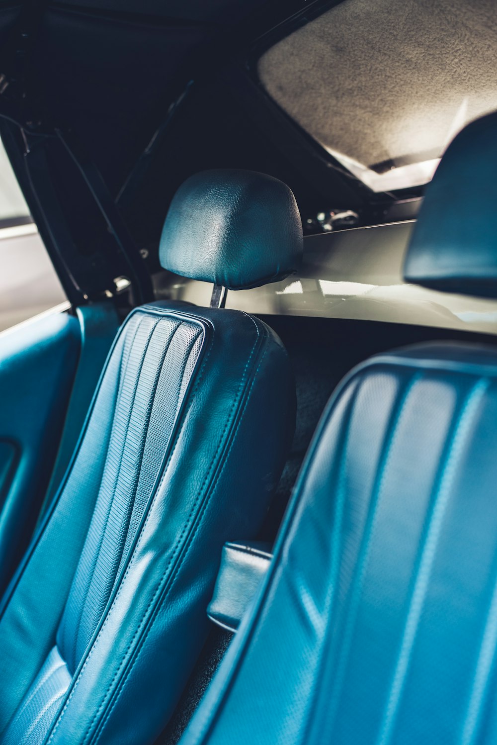 the interior of a car with blue leather seats