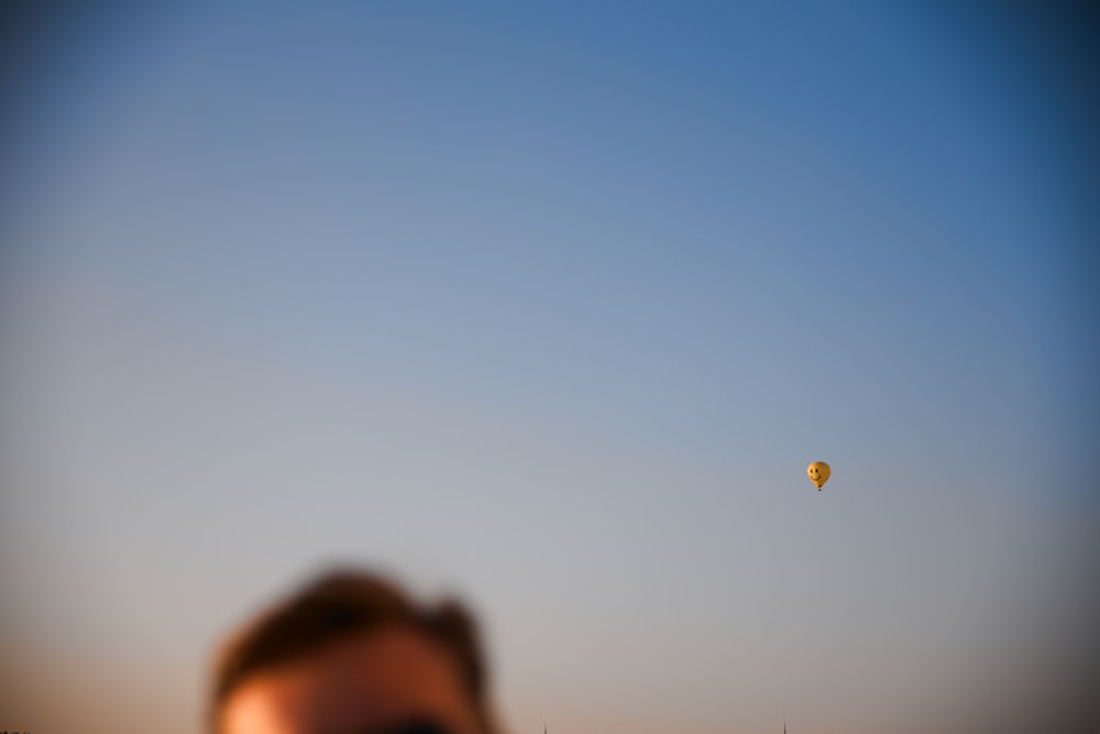 a blurry photo of a person flying a kite