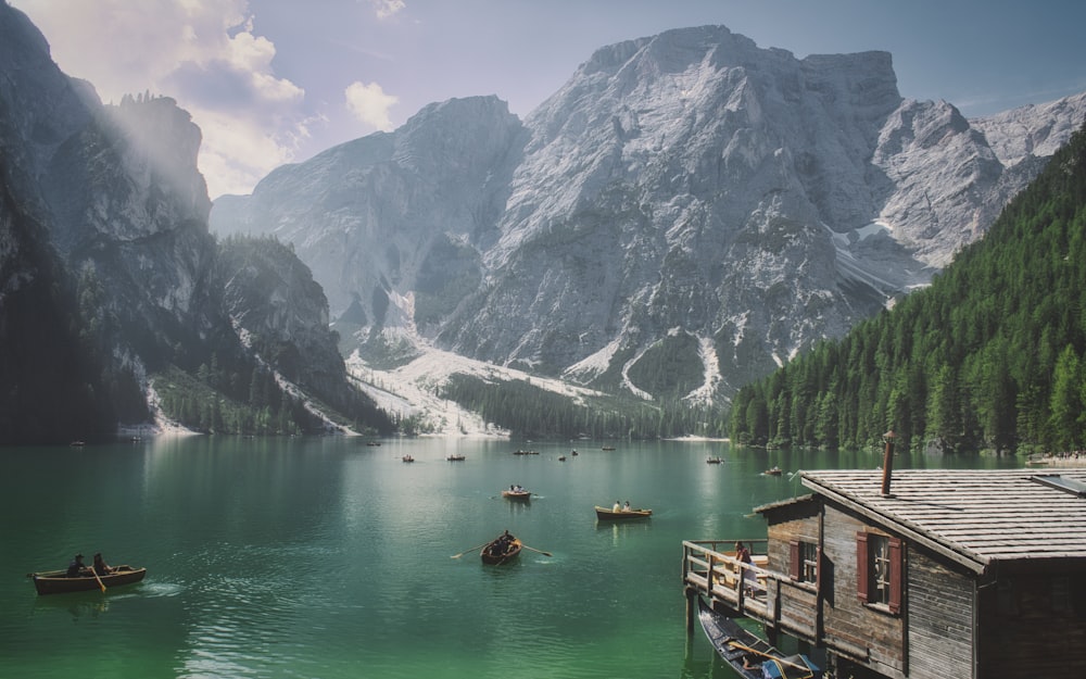 a group of boats floating on top of a lake