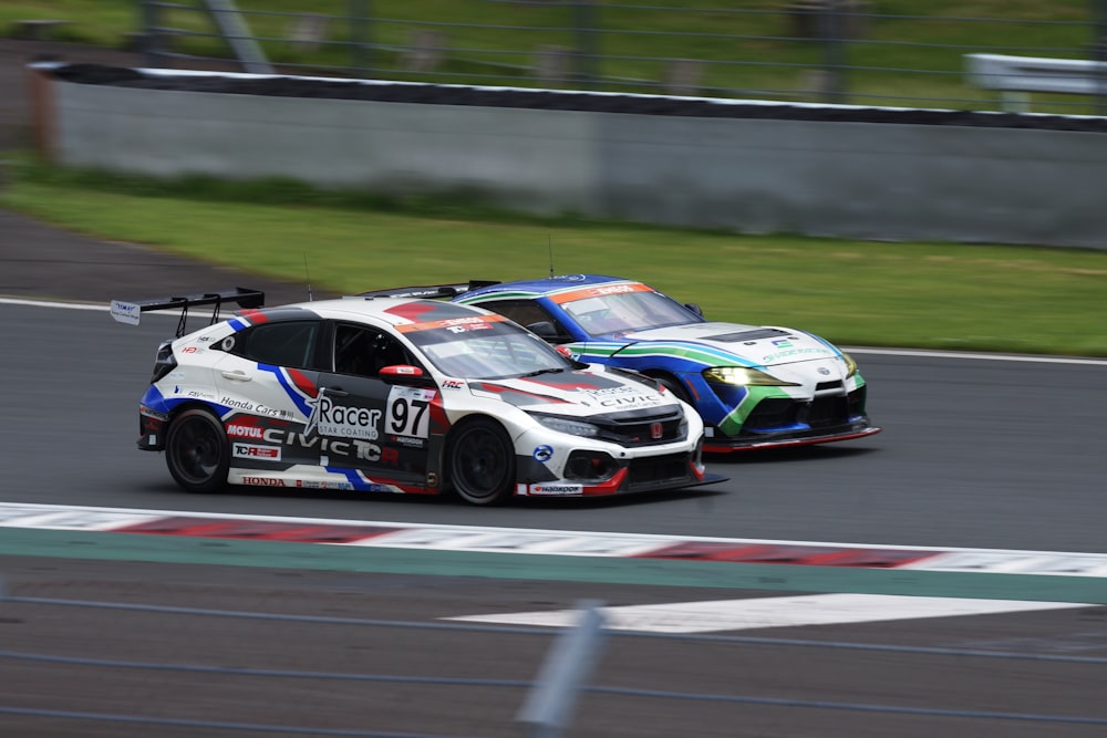 two racing cars driving on a race track