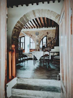 A renovated quincho area with wooden beams and cozy lighting.