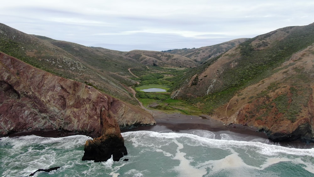 an aerial view of a body of water with mountains in the background