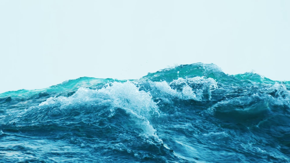 a person riding a surfboard on top of a wave