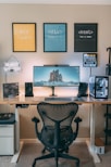 a desk with a computer and speakers on it