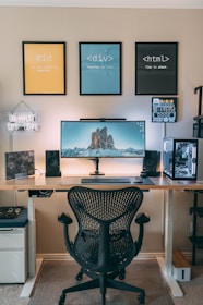 a desk with a computer and speakers on it