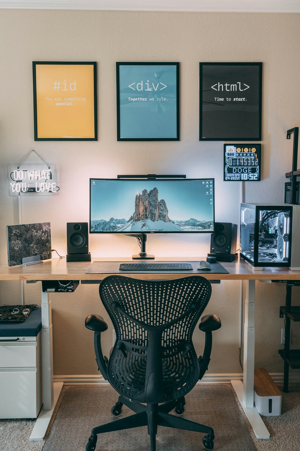 a desk with a computer and speakers on it