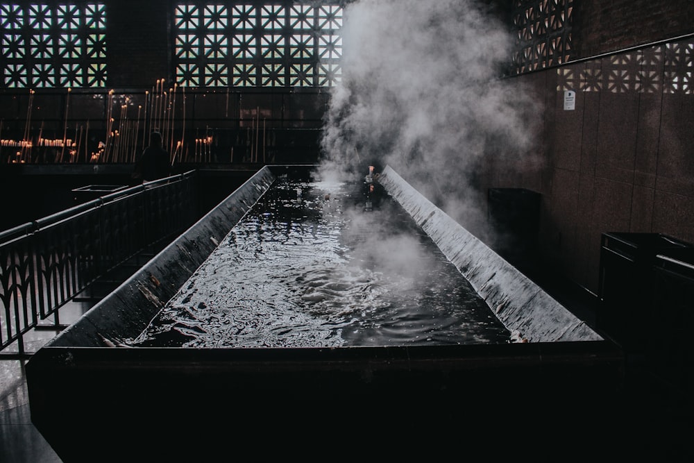 a large pool of water with steam coming out of it