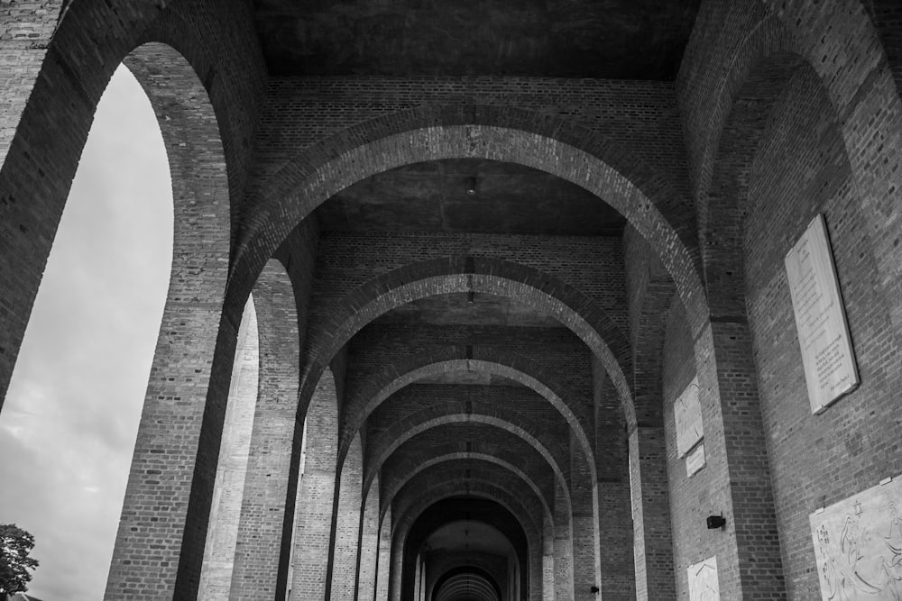 a black and white photo of a long hallway