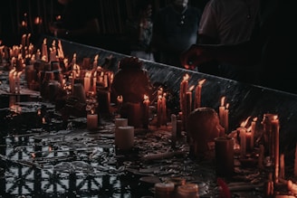 a long table with many lit candles on it