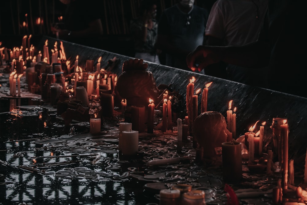 a long table with many lit candles on it