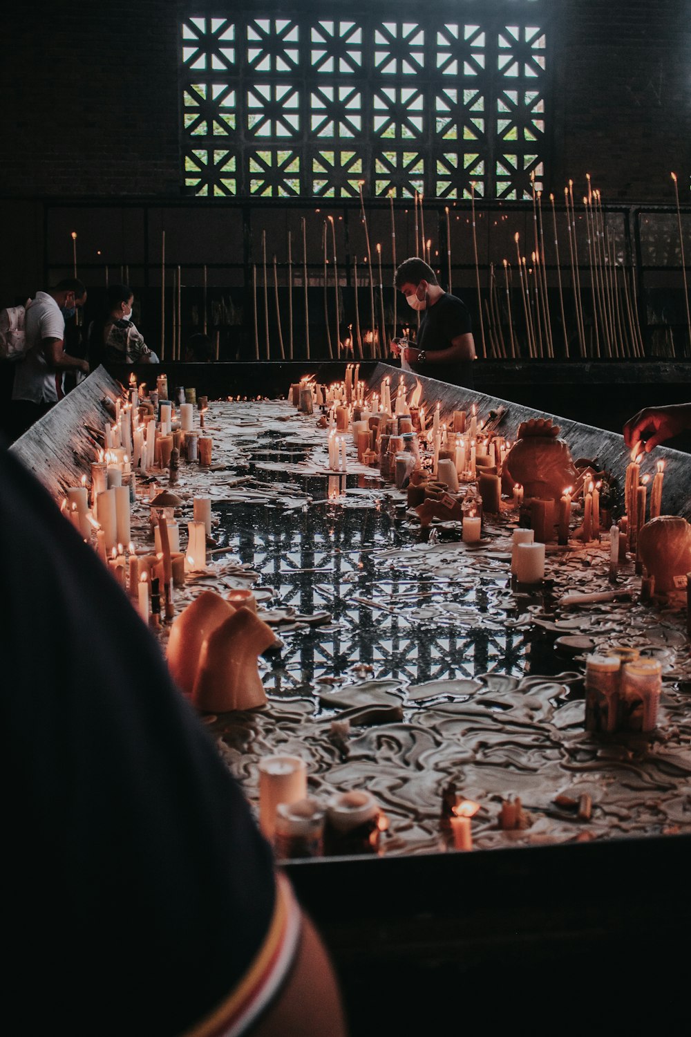 a long table with many lit candles on it