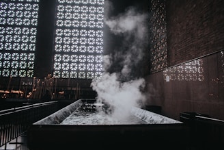 Traditional Moroccan hammam interior with steam and tiled walls.
