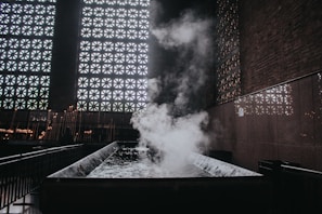 A Moroccan bath setup with traditional decor and warm steam enveloping the space.