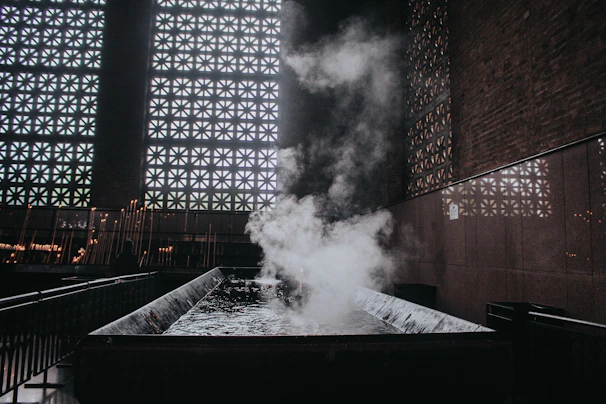 The calming ambiance of the Moroccan bath area with intricate tile work and steam rising.