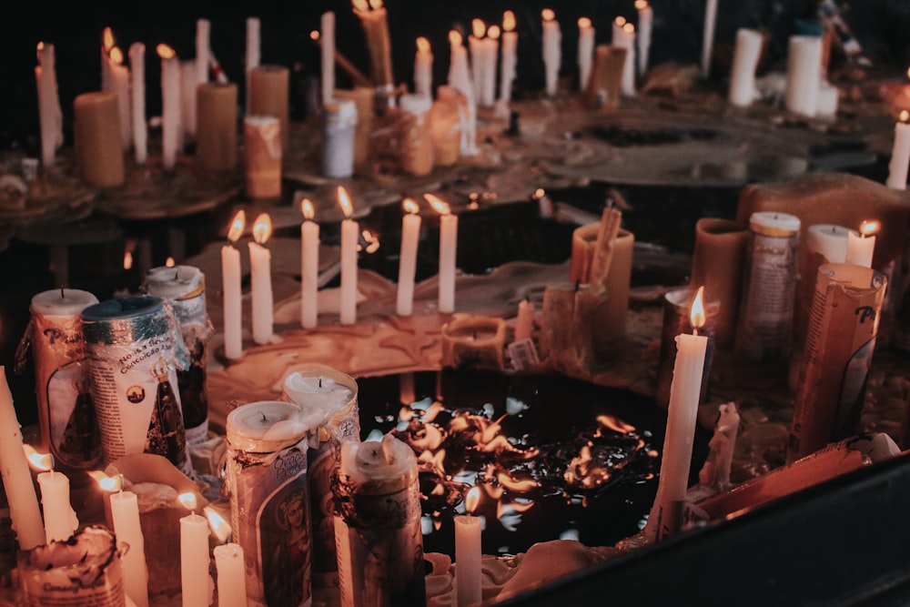 a bunch of candles that are on a table