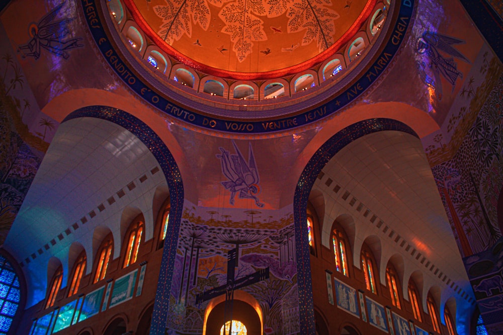 the inside of a church with a clock on the ceiling