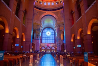 the inside of a large building with a clock on the wall