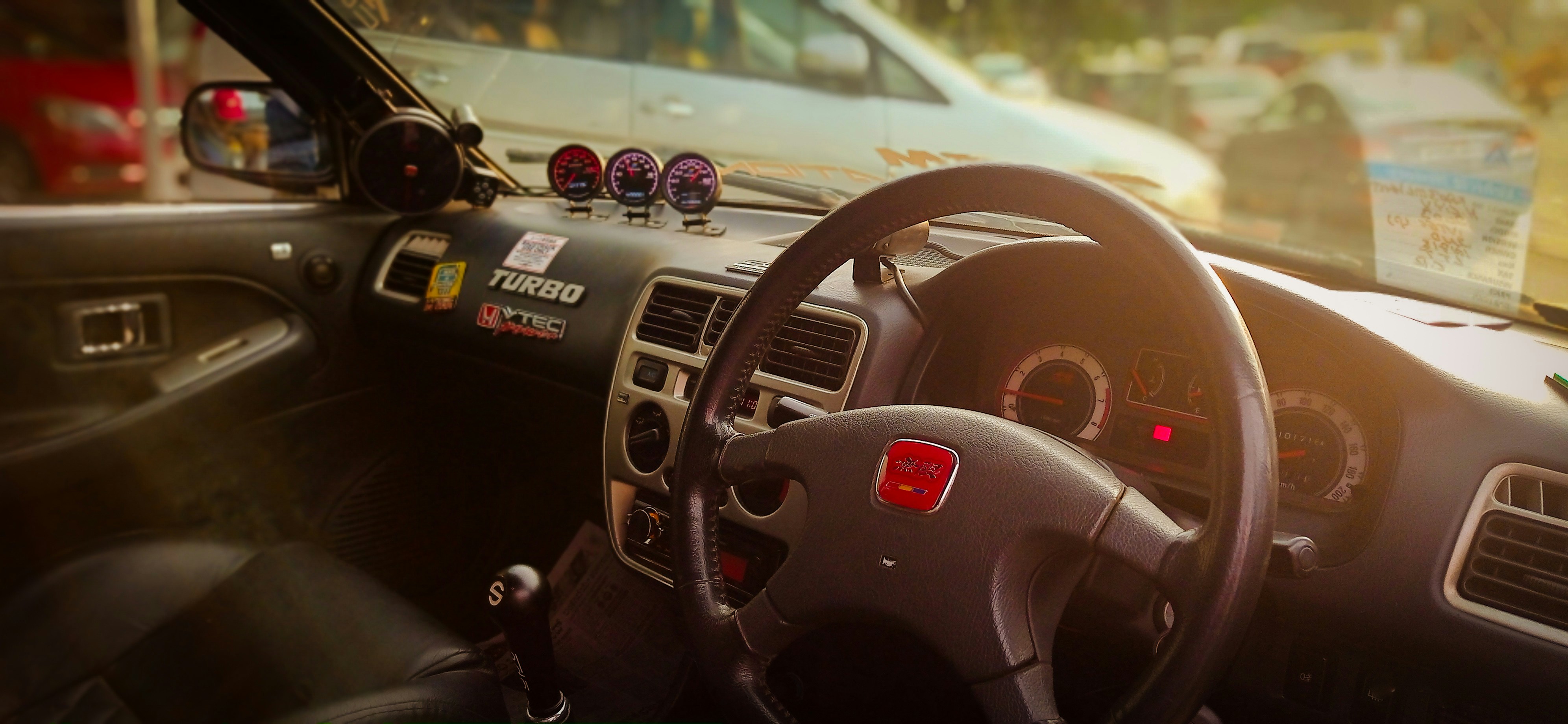 Illuminated car dashboard warning lights at dusk