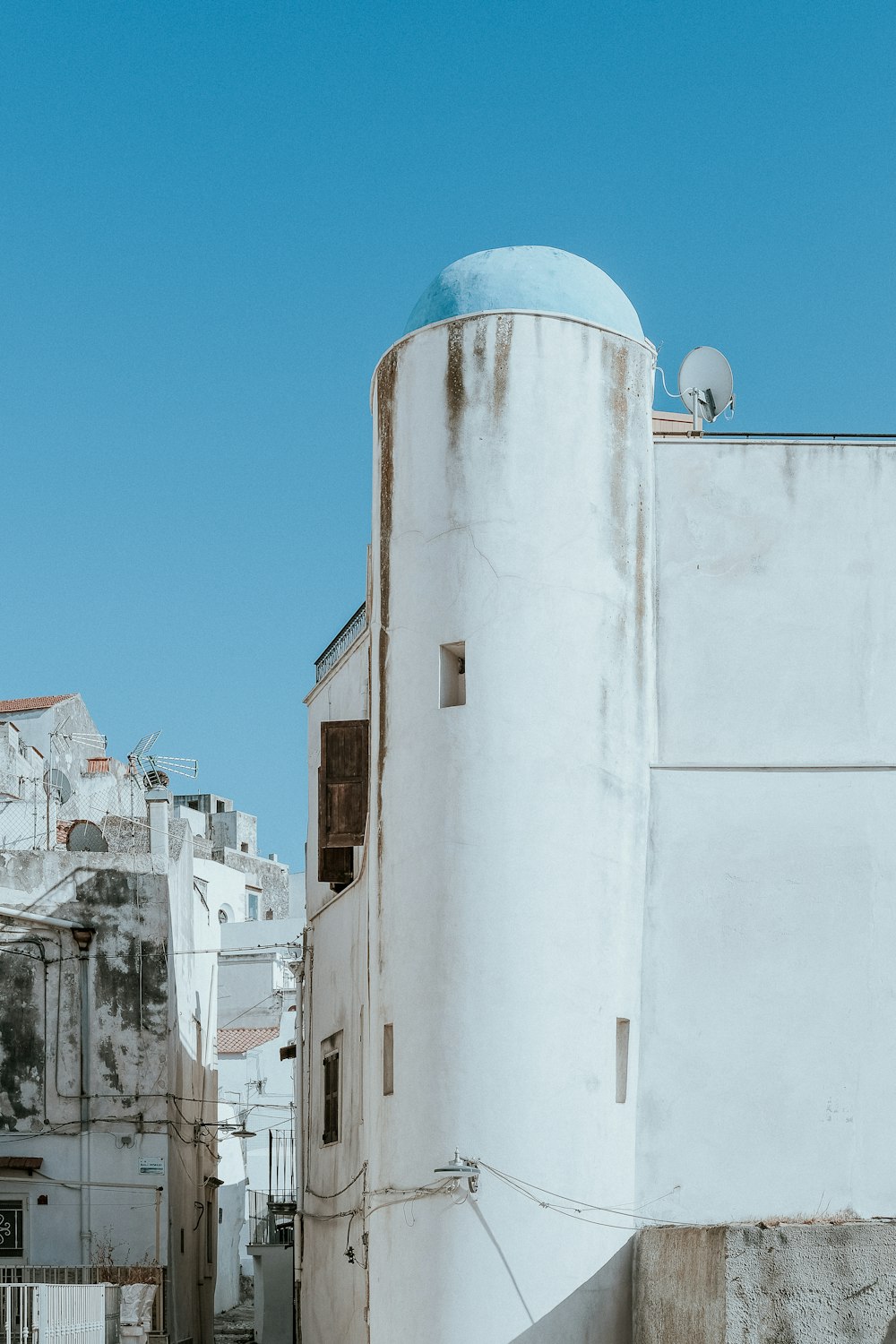 a white building with a blue dome on top of it