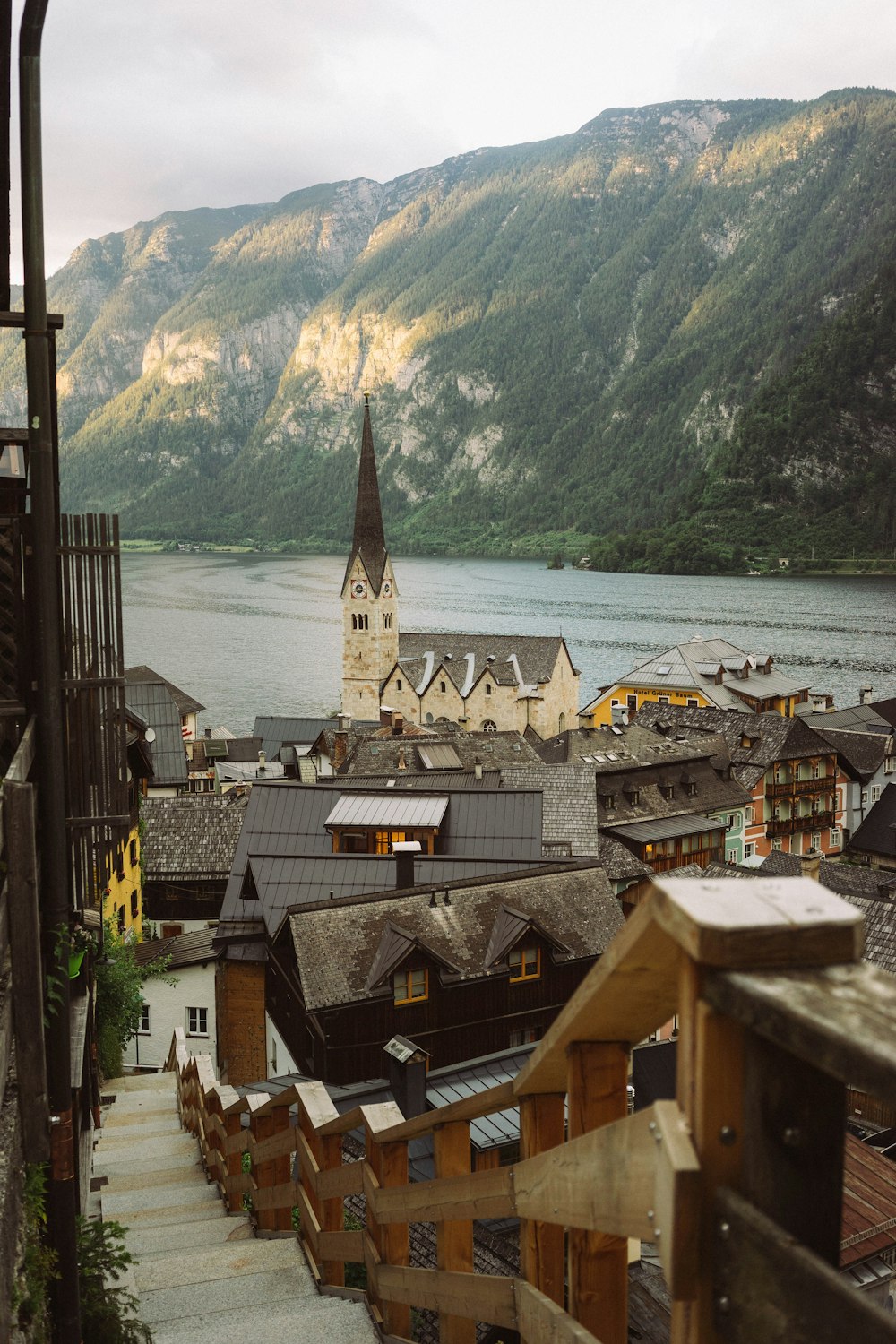 a view of a town with a church and mountains in the background