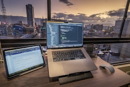 a laptop computer sitting on top of a wooden desk