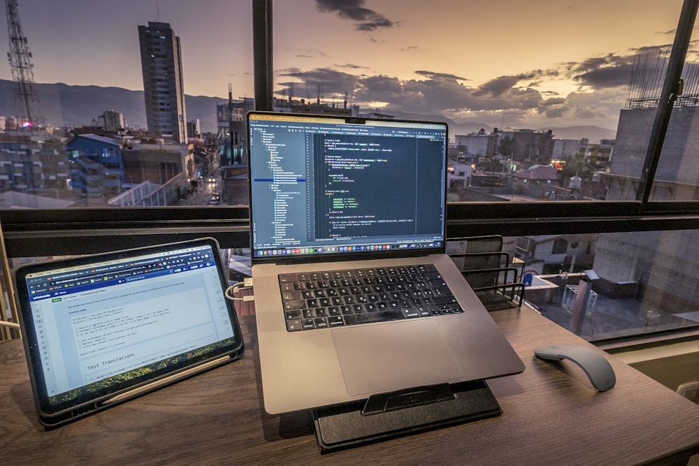 a laptop computer sitting on top of a wooden desk