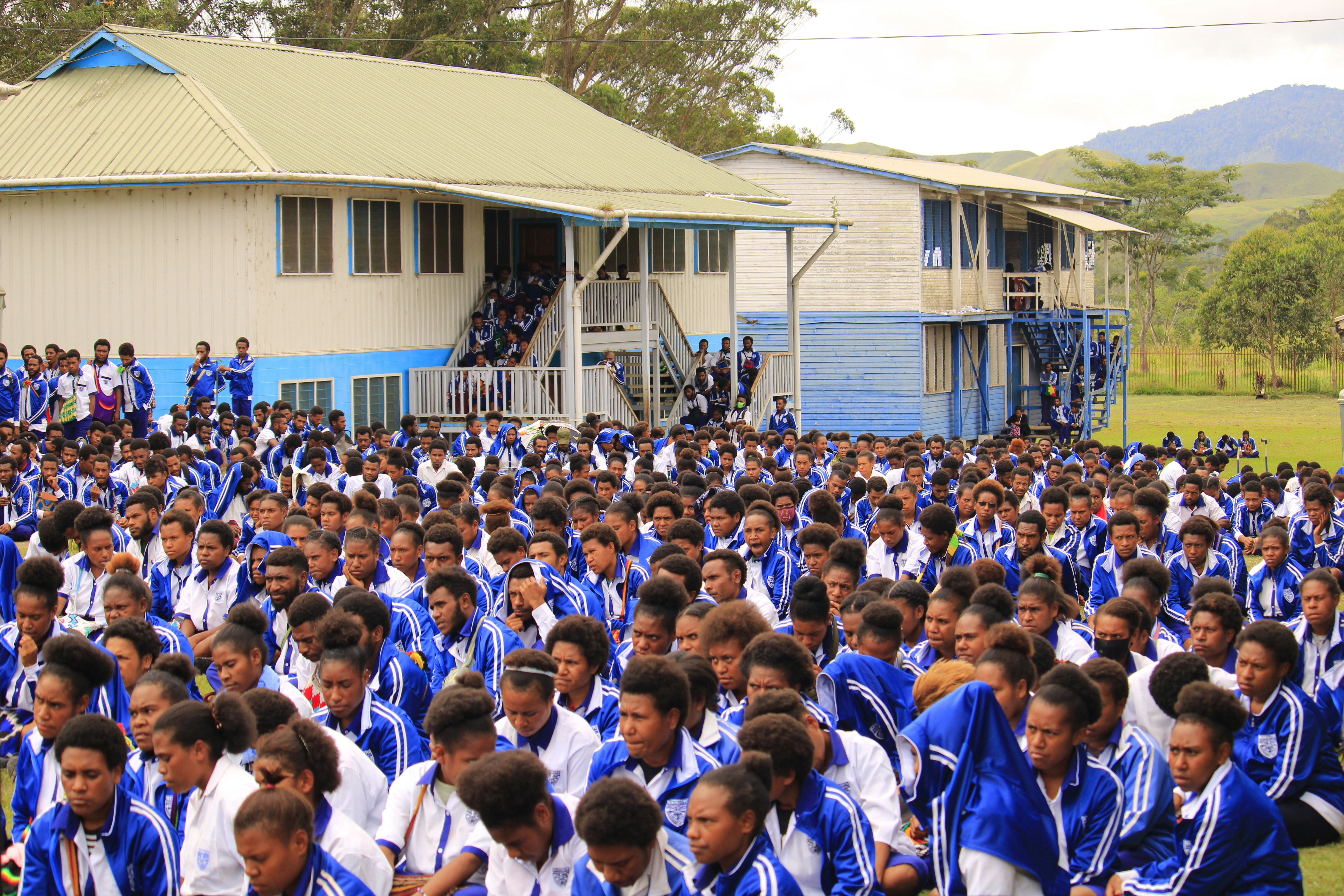 a large group of people standing in front of a building