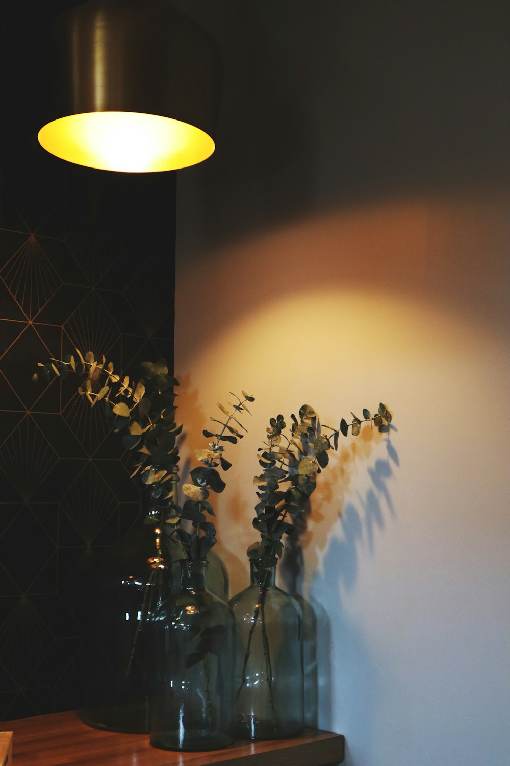 a couple of vases sitting on top of a wooden table