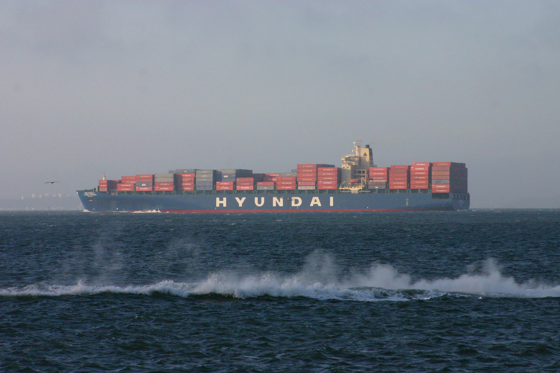 a large cargo ship in the middle of the ocean