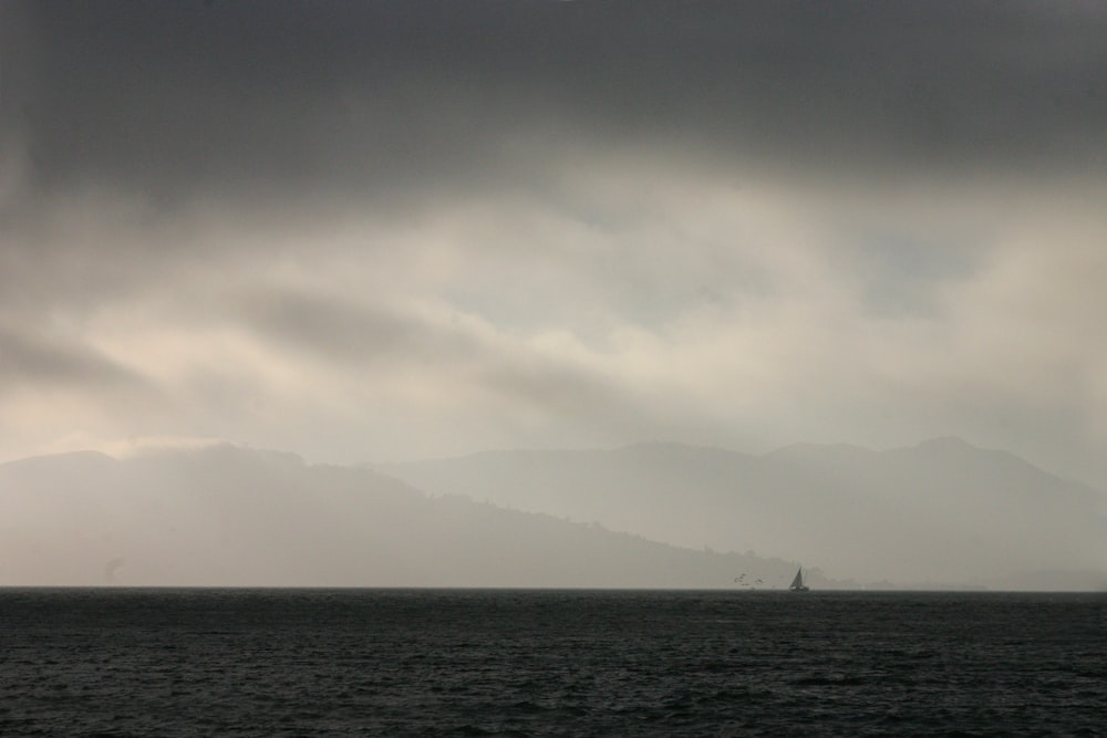 a large body of water under a cloudy sky