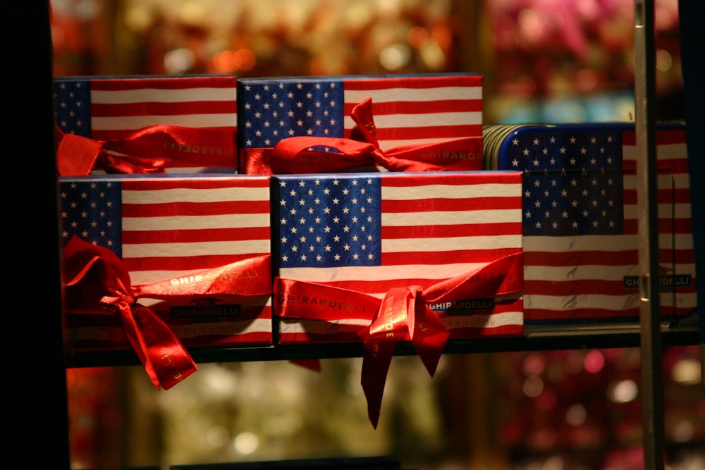 a display of american flags wrapped in red, white and blue ribbon