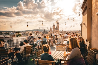 a group of people sitting on top of a wooden bench