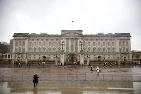 two people standing in front of a large building