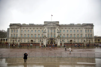 two people standing in front of a large building