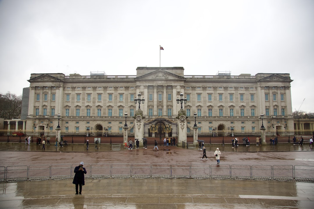 two people standing in front of a large building,